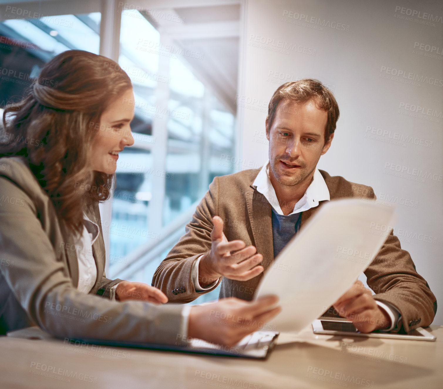 Buy stock photo Cropped shot of two businesspeople working together in the boardroom