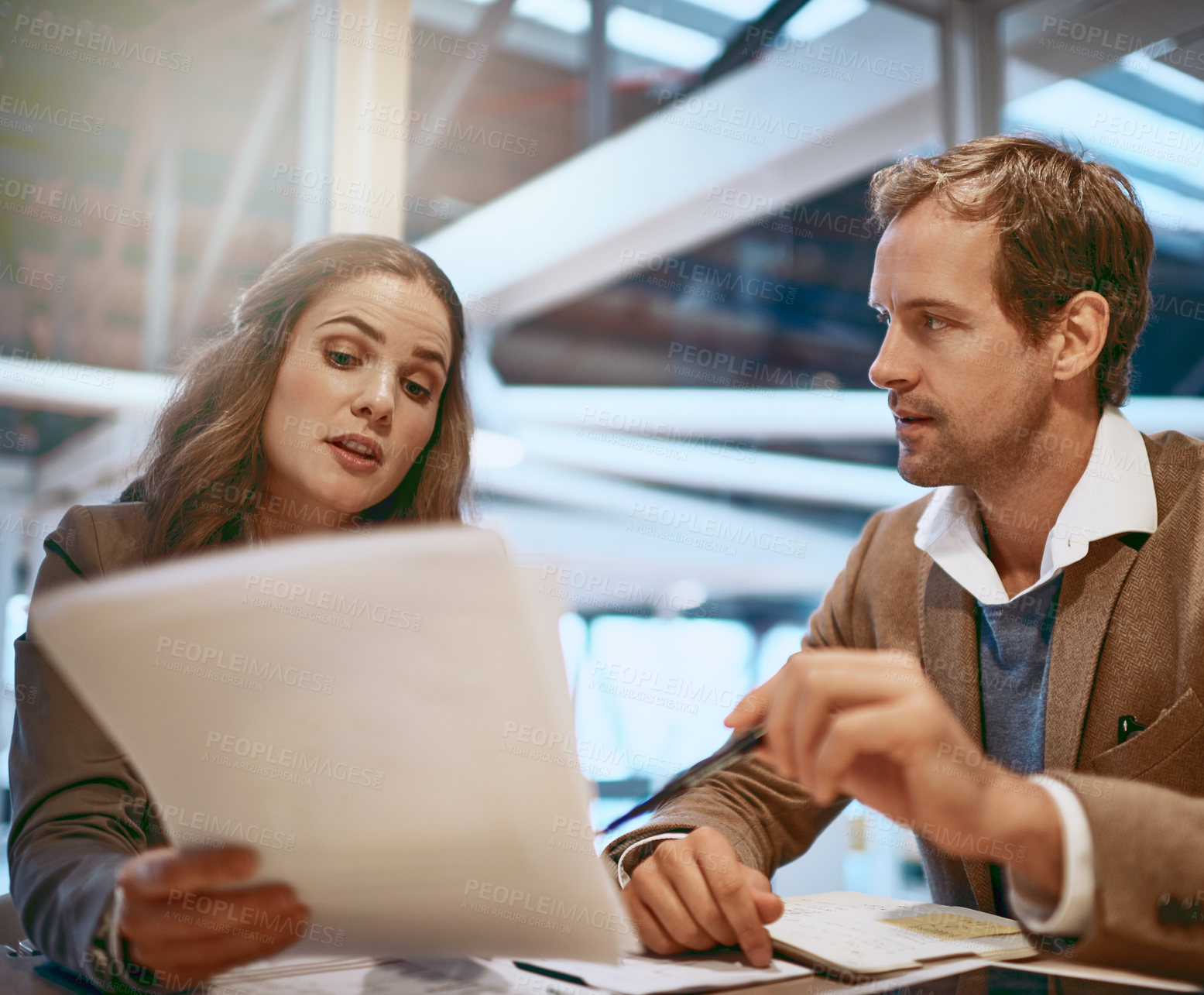 Buy stock photo Cropped shot of two businesspeople working together in the boardroom