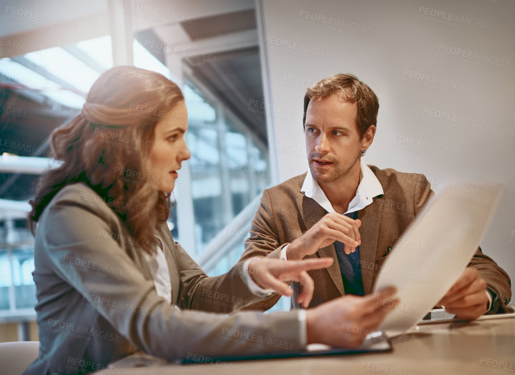 Buy stock photo Cropped shot of two businesspeople working together in the boardroom