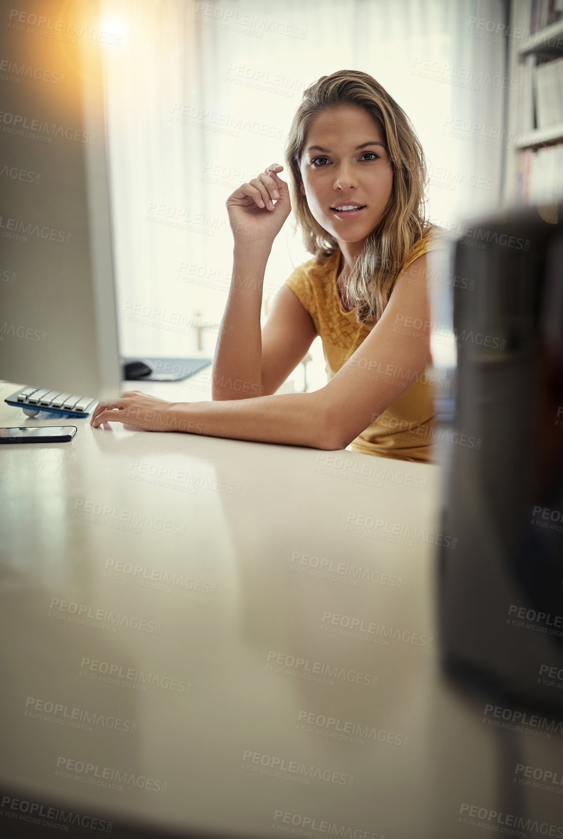 Buy stock photo Portrait of a young woman working on a computer in her home office