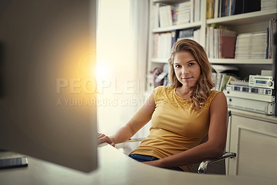 Buy stock photo Portrait of a young woman working on a computer in her home office