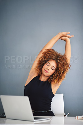 Buy stock photo Shot of a young businesswoman feeling relaxed at her desk