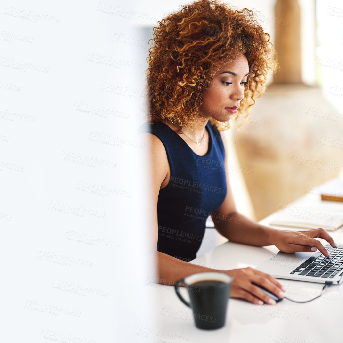 Buy stock photo Cropped shot of a young businesswoman working on her laptop