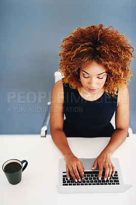 Buy stock photo Cropped shot of a young businesswoman working on her laptop