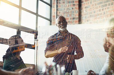 Buy stock photo Mature businessman giving a presentation in the boardroom superimposed over railway tracks. Elderly man having a conference or workshop meeting over double exposure background.