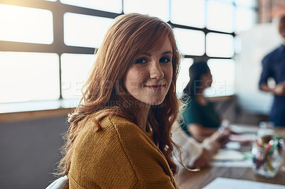 Buy stock photo Creative designer, entrepreneur and intern sitting at a boardroom table during a meeting in the office. Portrait of a motivated and ambitious young business woman looking happy and positive at work