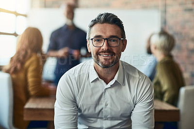 Buy stock photo Cropped portrait of a mature businessman sitting in the boardroom during a presentation