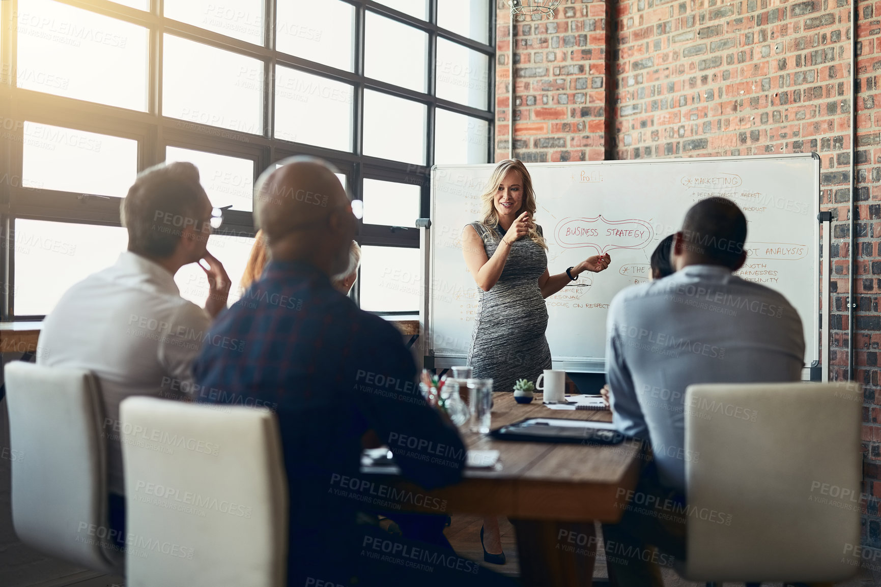 Buy stock photo Confident, leadership and power by a business woman doing a presentation on a board to a group in a conference room. Happy woman explaining an idea or marketing strategy for a startup to investors