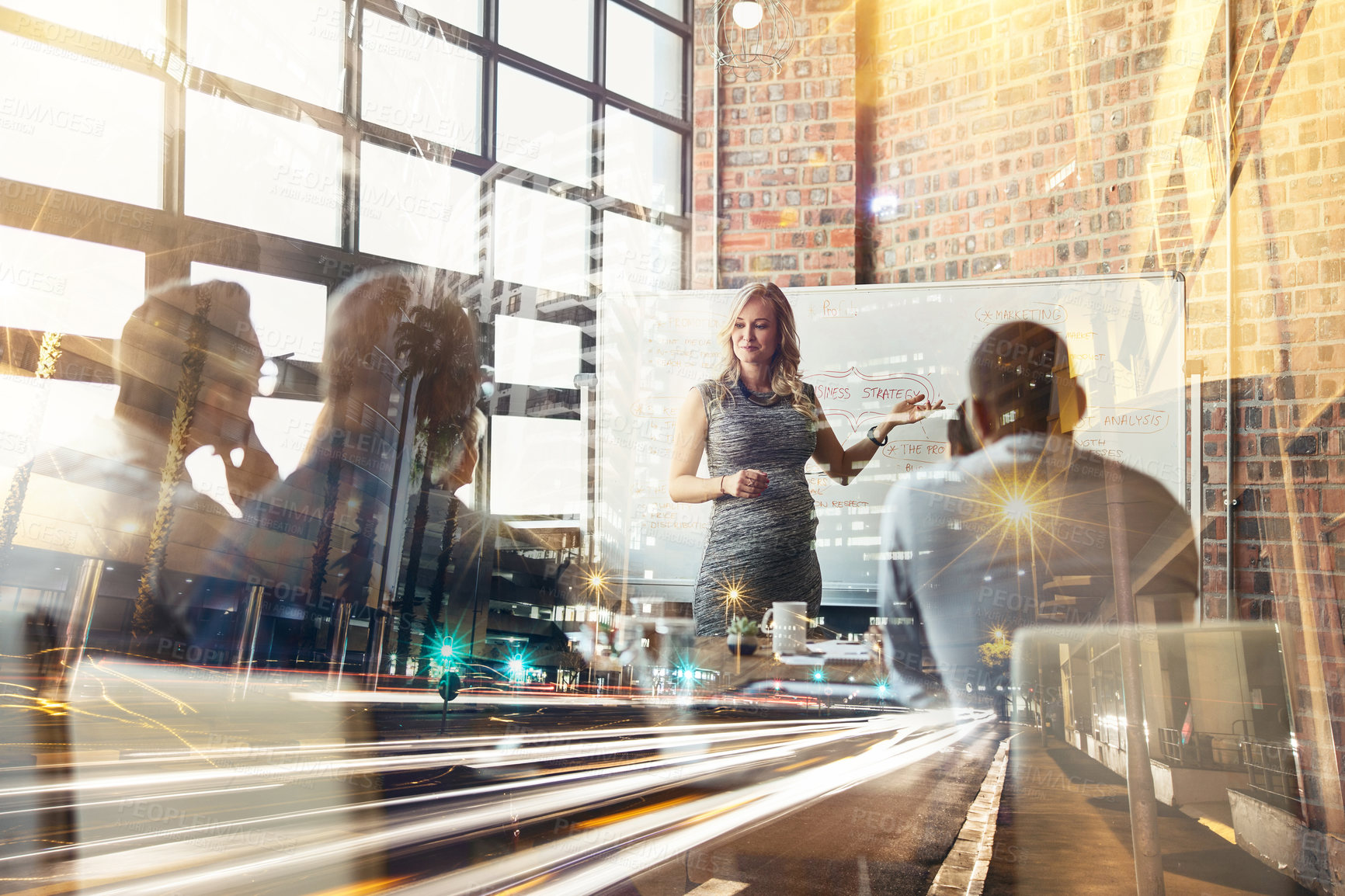 Buy stock photo Shot of corporate businesspeople in the boardroom superimposed over a busy city street