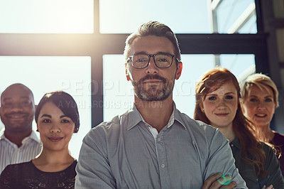 Buy stock photo Cropped shot of a group of business colleagues standing in the office with confidence and looking at the camera