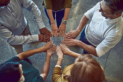 Buy stock photo Business people making circle with hands, doing team building and showing support standing together at work from above. Colleagues making shape with fingers and expressing unity, trust and community