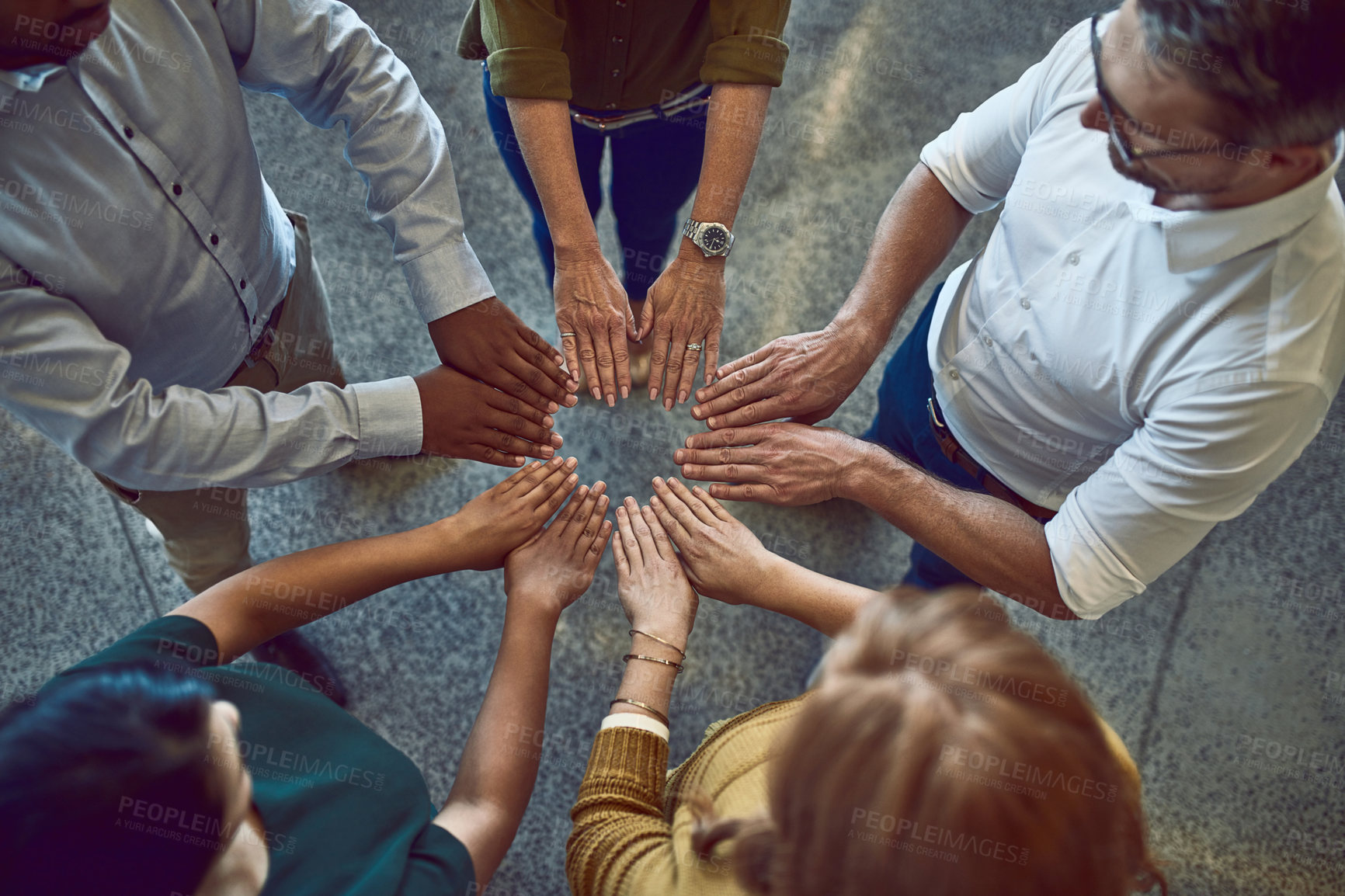 Buy stock photo Business people making circle with hands, doing team building and showing support standing together at work from above. Colleagues making shape with fingers and expressing unity, trust and community