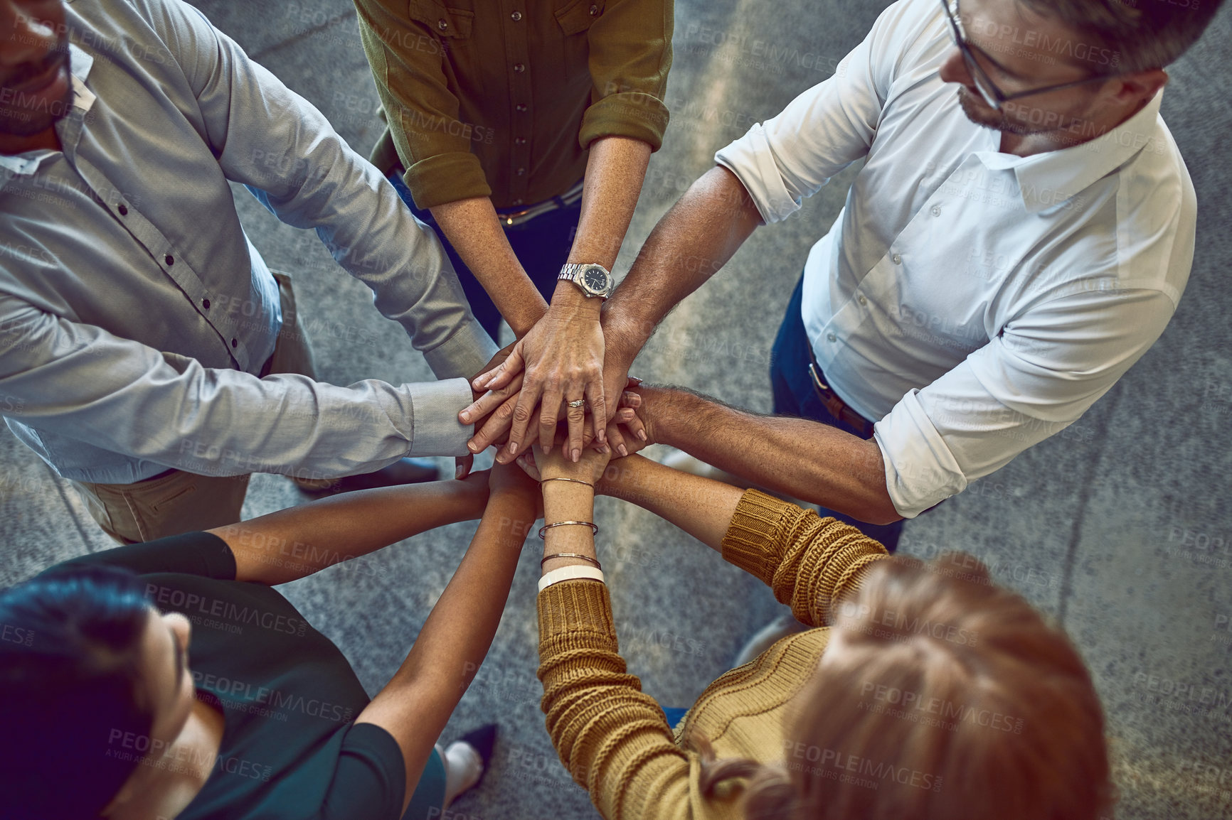 Buy stock photo Successful, celebrating and winning colleagues stack hands in unity, support and trust during team building. A group of cheerful business people putting palms together enjoying success in the office