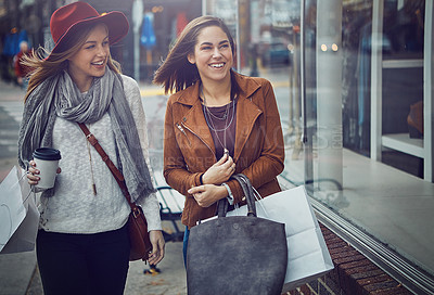Buy stock photo Cropped shot of two young girlfriends walking around downtown while on a shopping spree