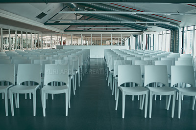 Buy stock photo Shot of an empty office filled with chairs and surrounded with glass windows on the sides