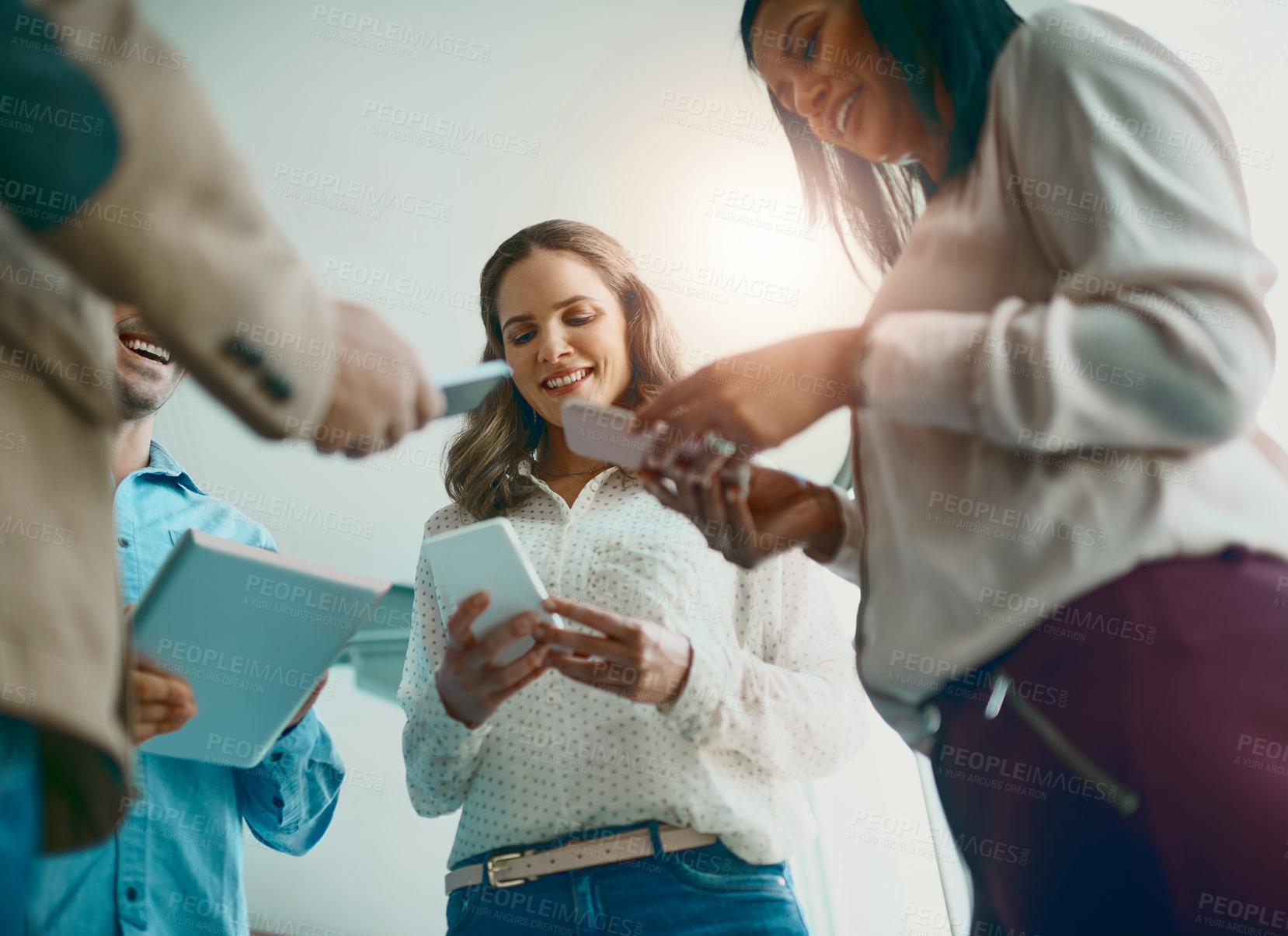 Buy stock photo Shot of businesspeople making use of mobile platforms to to expand their business and to connect people