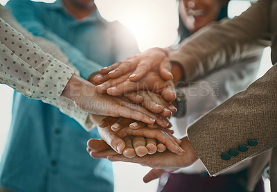 Buy stock photo Cropped shot of a group of unrecognizable businesspeople standing in the office with their hands in a huddle