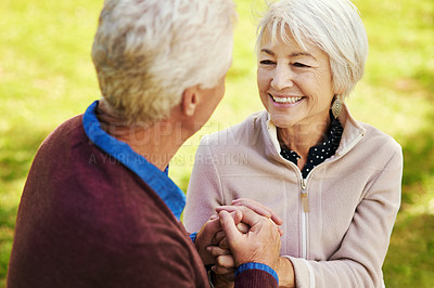 Buy stock photo Old couple, holding hands with love and comfort outside in park with smile and happiness together with bonding. Happy, man and woman with travel, relationship with marriage and trust in retirement