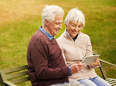 Buy stock photo Internet, park and senior couple with a tablet for communication, video call and scrolling. Nature, hug and elderly man and woman with technology for social media and reading an email in Argentina