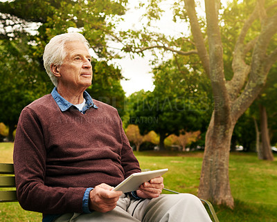 Buy stock photo Relax, tablet and thinking with old man in park for social media, freedom and communication. Technology, internet and contact with senior citizen on bench in nature for website, peace and retirement