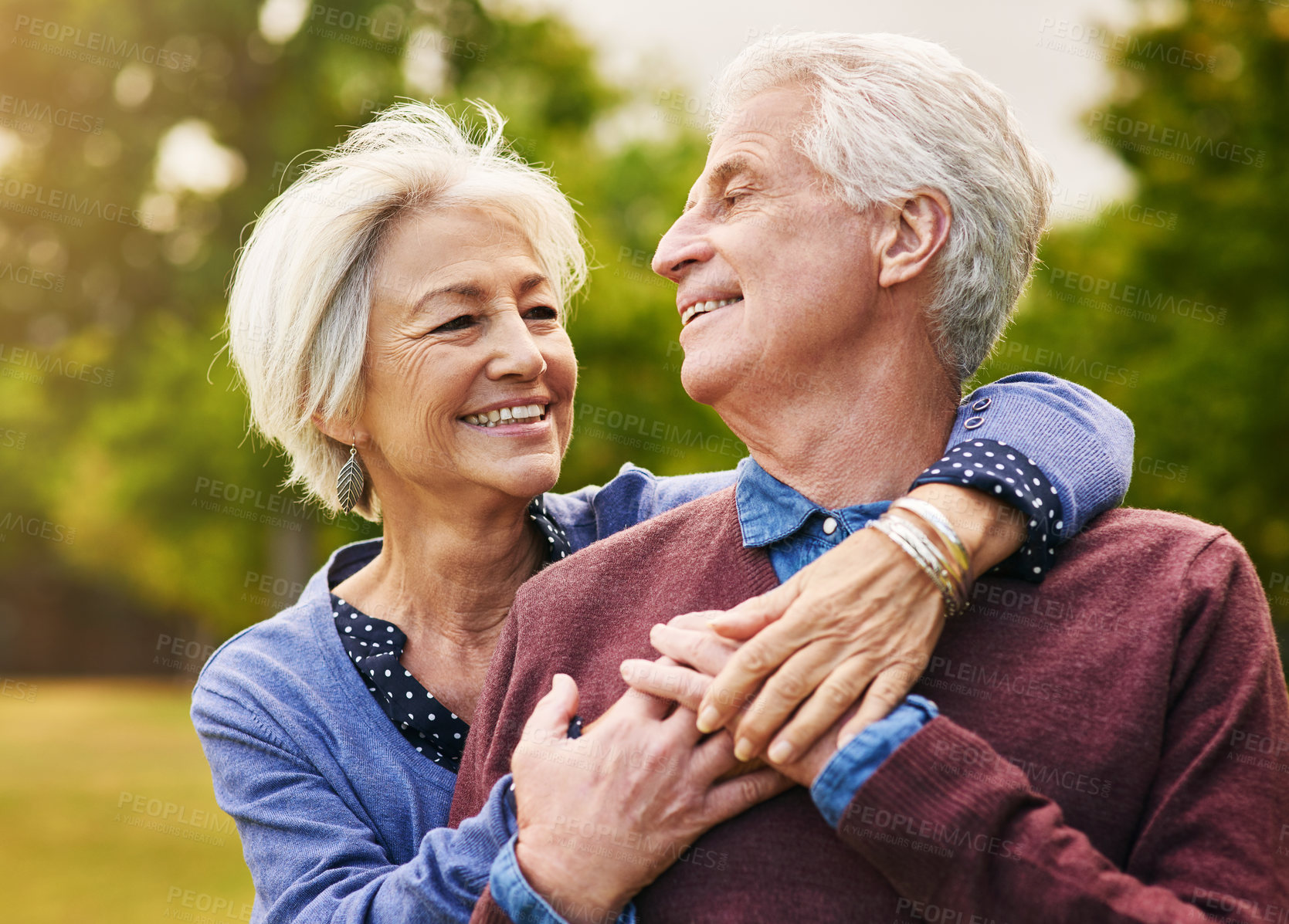 Buy stock photo Old couple hug, smile in the park and happiness together outdoor, bonding in nature with love and retirement. Happy, man and woman with travel, relationship with trust in marriage and commitment