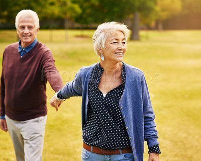 Buy stock photo Romance, retirement and old couple holding hands in field, walking in nature and happy smile on grass. Peace, senior man and woman on romantic walk in park, health and love on holiday in countryside.