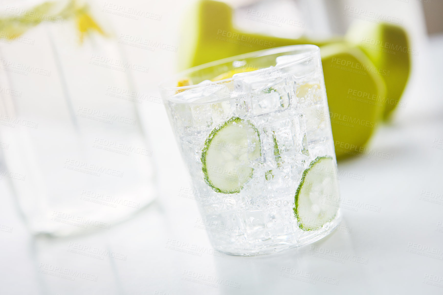 Buy stock photo Shot of a glass of water with slices of lemon and cucumber in
