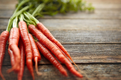 Buy stock photo Shot of a bunch of fresh carrots on a table
