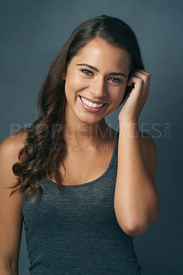 Buy stock photo Happy, smile and portrait of woman in studio with healthy hair for wellness, texture and growth. Flirting, attractive and face of isolated person with confidence, beauty and pride on gray background