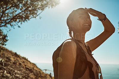 Buy stock photo Shot of a young woman admiring the view from the top of a mountain