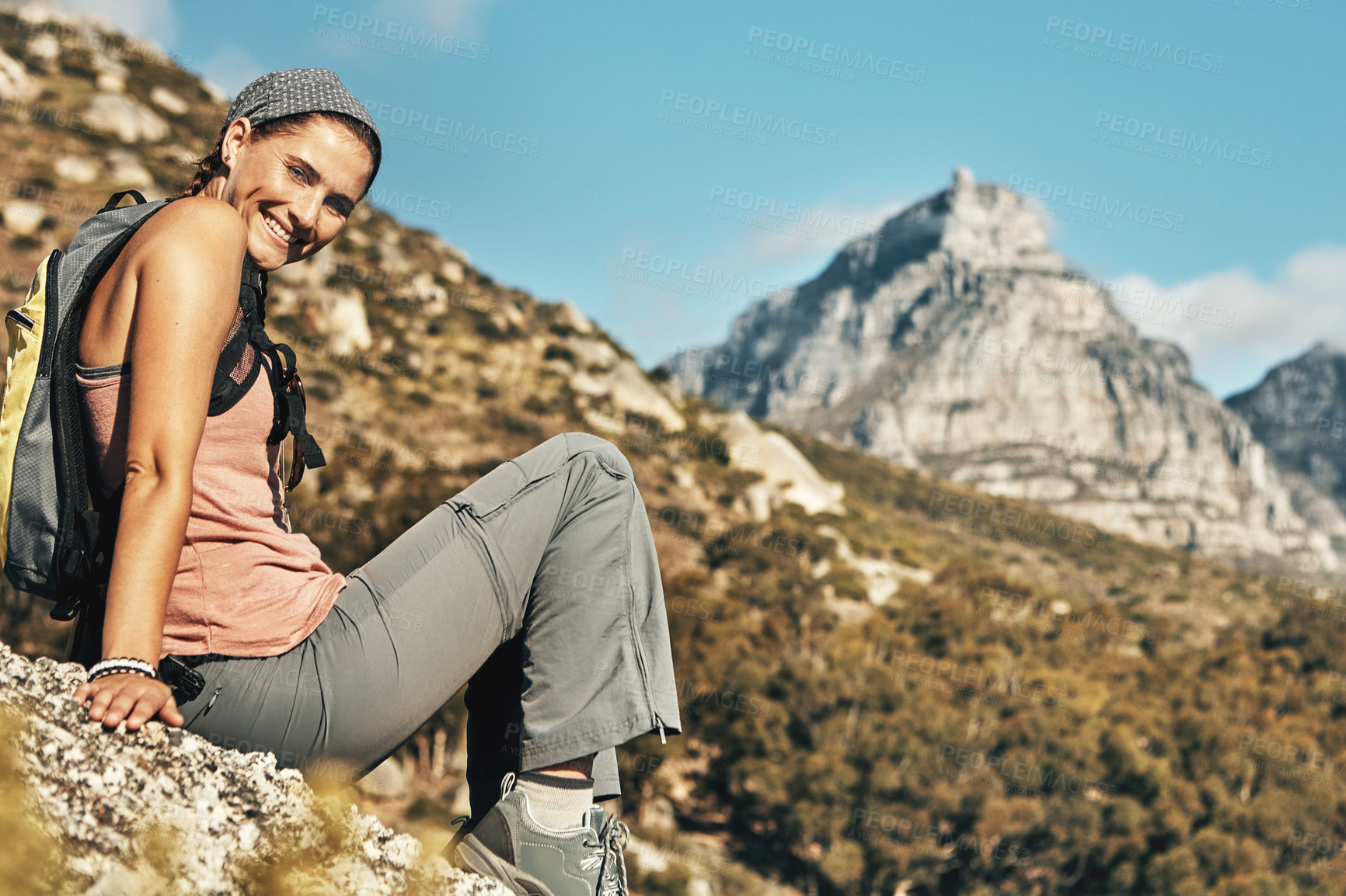 Buy stock photo Portrait of a young woman taking a break while out on a hike through the mountains