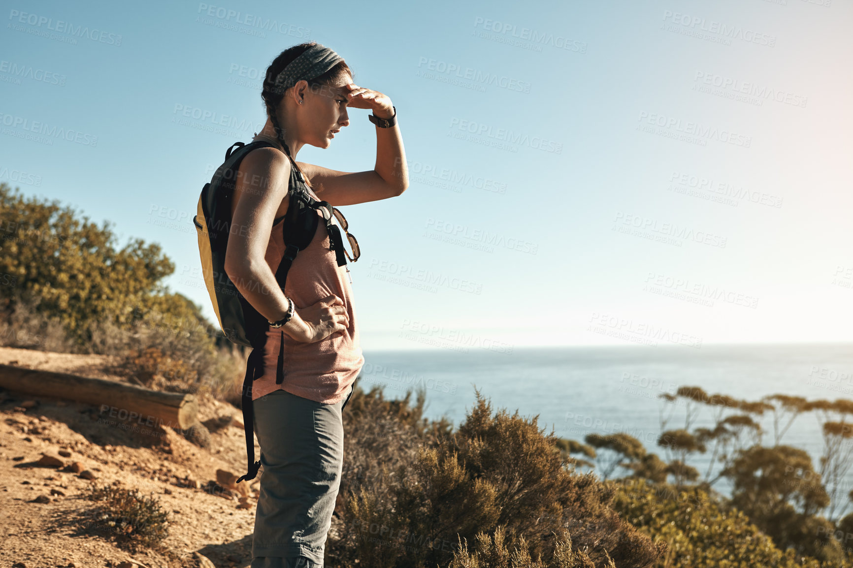 Buy stock photo Shot of a young woman admiring the view from the top of a mountain