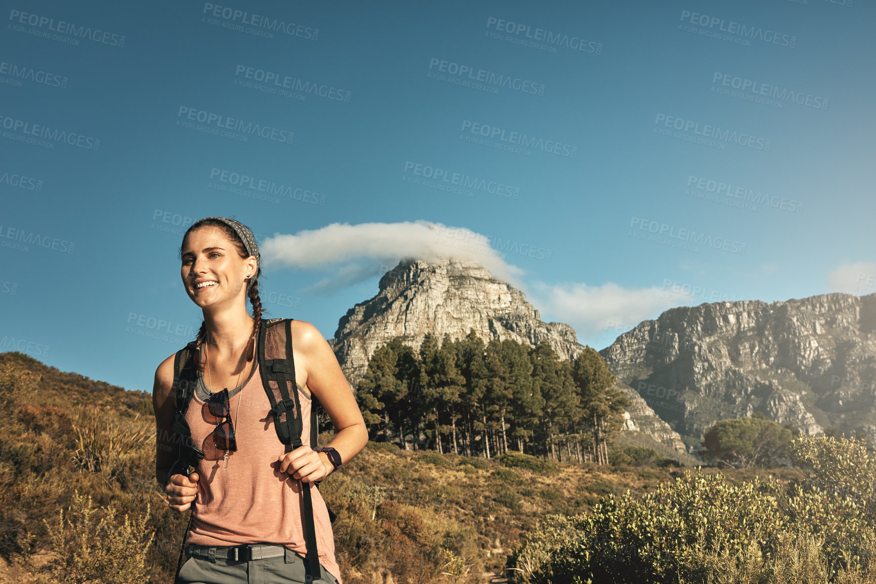 Buy stock photo Shot of a young woman out on a hike through the mountains