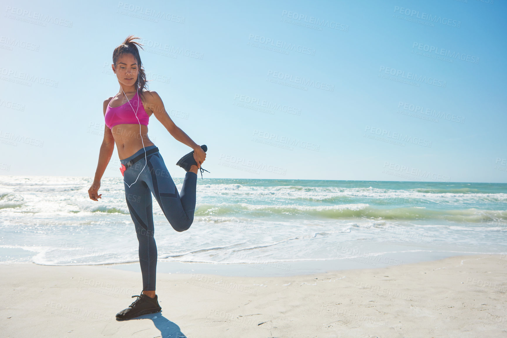 Buy stock photo Shot of an attractive young woman working out on the beach