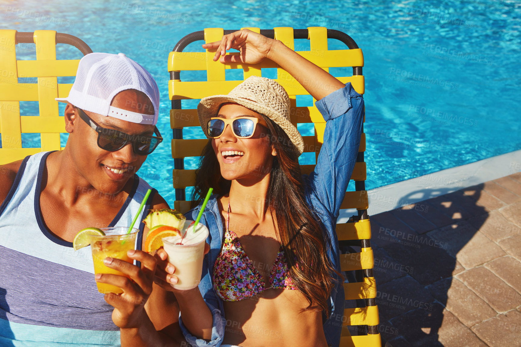 Buy stock photo Couple, poolside and alcohol for toast on holiday, outdoor and travel to hotel resort for vacation. People, love and sunglasses by water for drinks, bonding and cheers by swimming pool for wellness