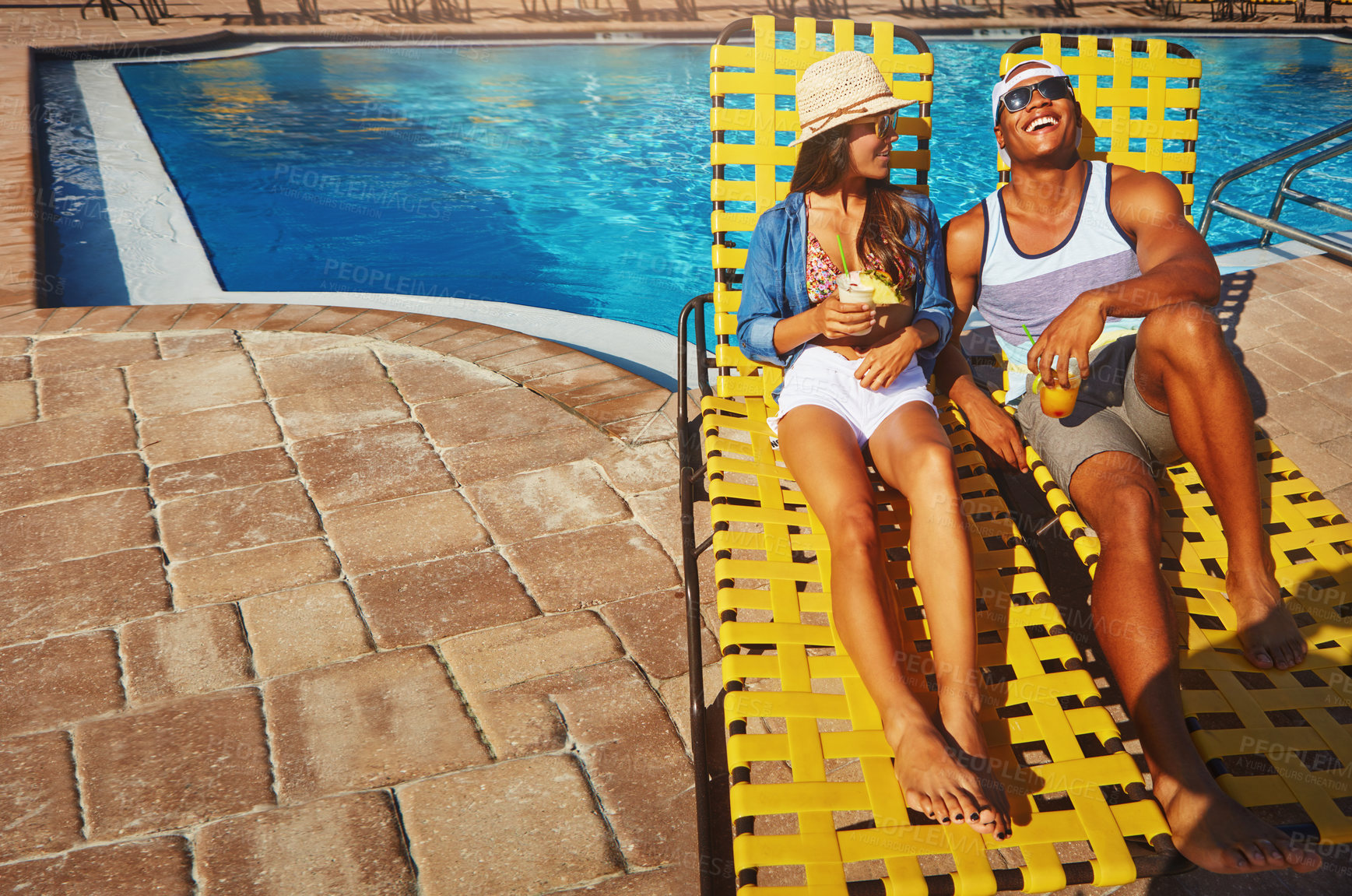 Buy stock photo Couple, poolside and alcohol to relax on weekend, outdoor and travel to hotel resort for vacation. People, peace and sunglasses by water for drinks, bonding and love by swimming pool for wellness