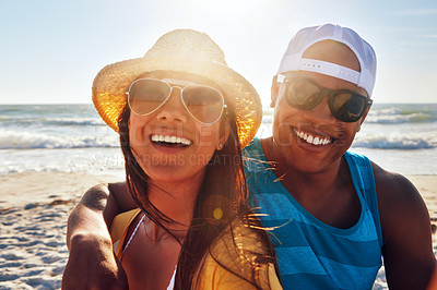 Buy stock photo Portrait of a young couple sitting on the beach on a sunny day