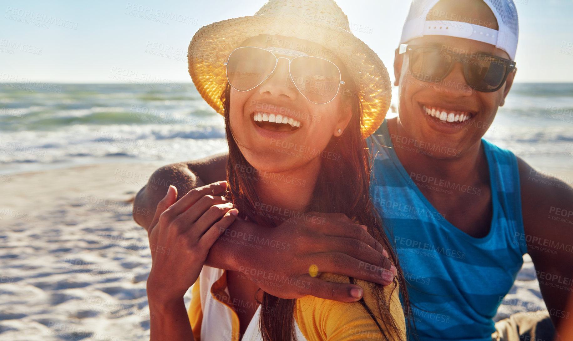 Buy stock photo Couple, portrait and happy at beach with sunset, sunglasses and relax for vacation by ocean in summer. Man, woman and smile on sand in Greece with blue sky, sun or partner on date for holiday or love