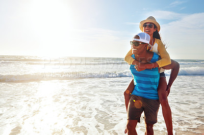 Buy stock photo Happy couple, beach and piggyback for holiday, vacation and bonding with romance, fun and adventure. Excited young man and woman in sunglasses in Miami for support, travel and love in lens flare