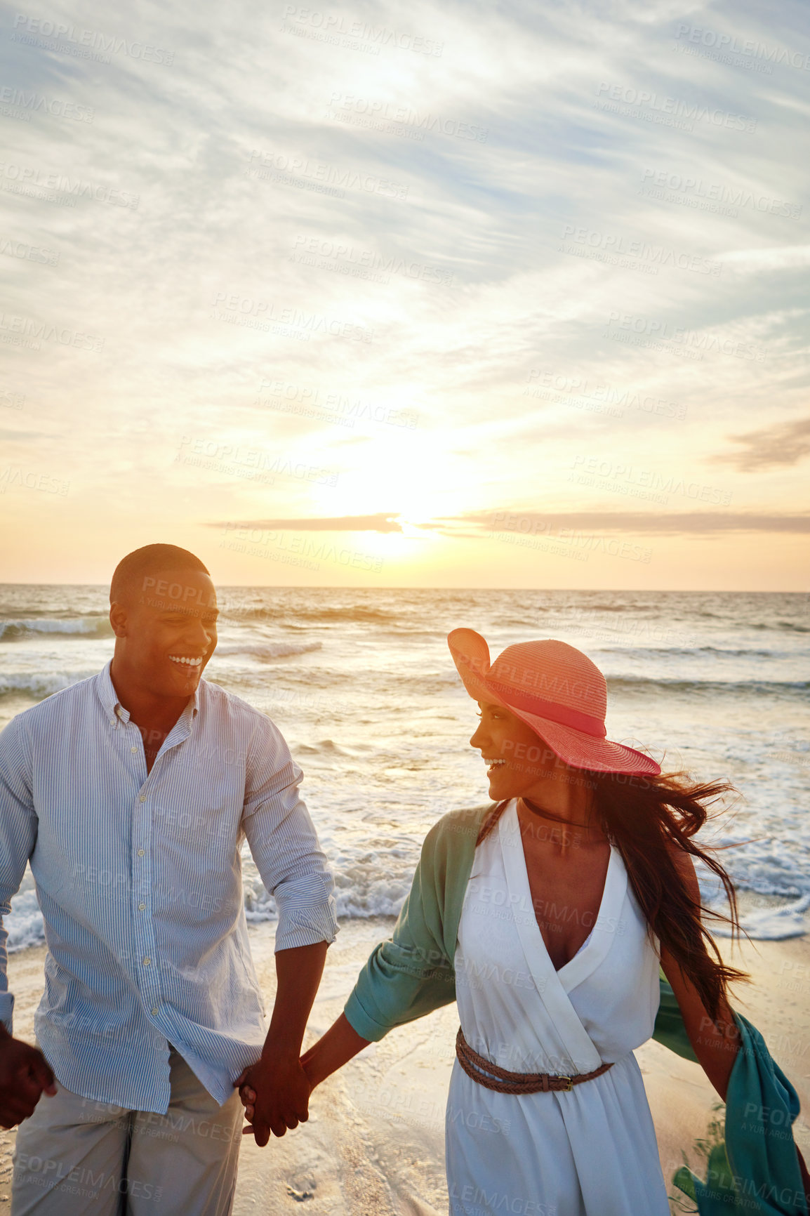 Buy stock photo Walking, holding hands and couple by sunset on ocean for adventure, holiday and bonding with laugh. Outdoor, beach and happiness of romantic people, boyfriend and girlfriend on vacation in Bali