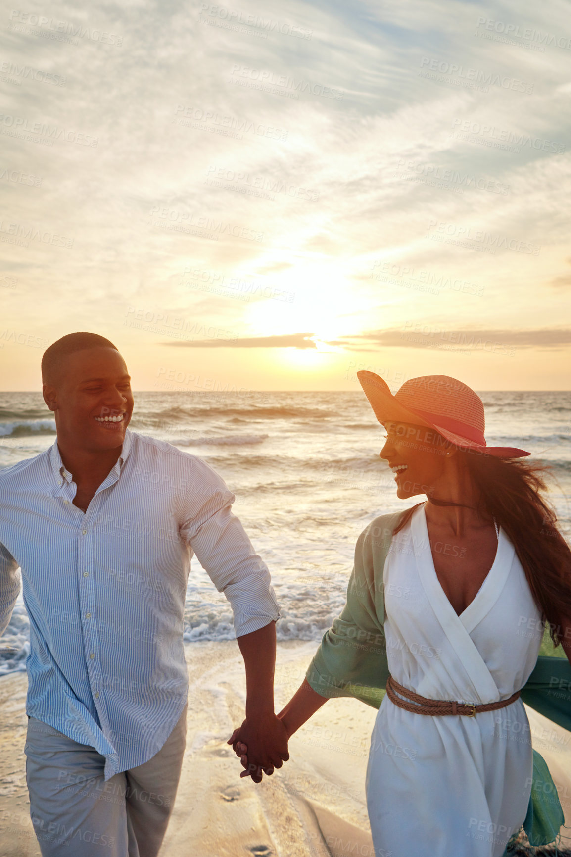 Buy stock photo Holding hands, love and couple by sunset on beach for adventure, holiday and bonding with laugh. Outdoor, ocean and seaside with people for walking, boyfriend and girlfriend on vacation in Bali