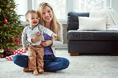 Buy stock photo Mother, baby and happy christmas while on floor in living room, holiday and cuddle for love. Smile, motherhood and toddler with woman together, hug and play by sitting for relationship at home