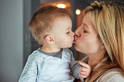 Buy stock photo Closeup shot of a young mother kissing her little boy