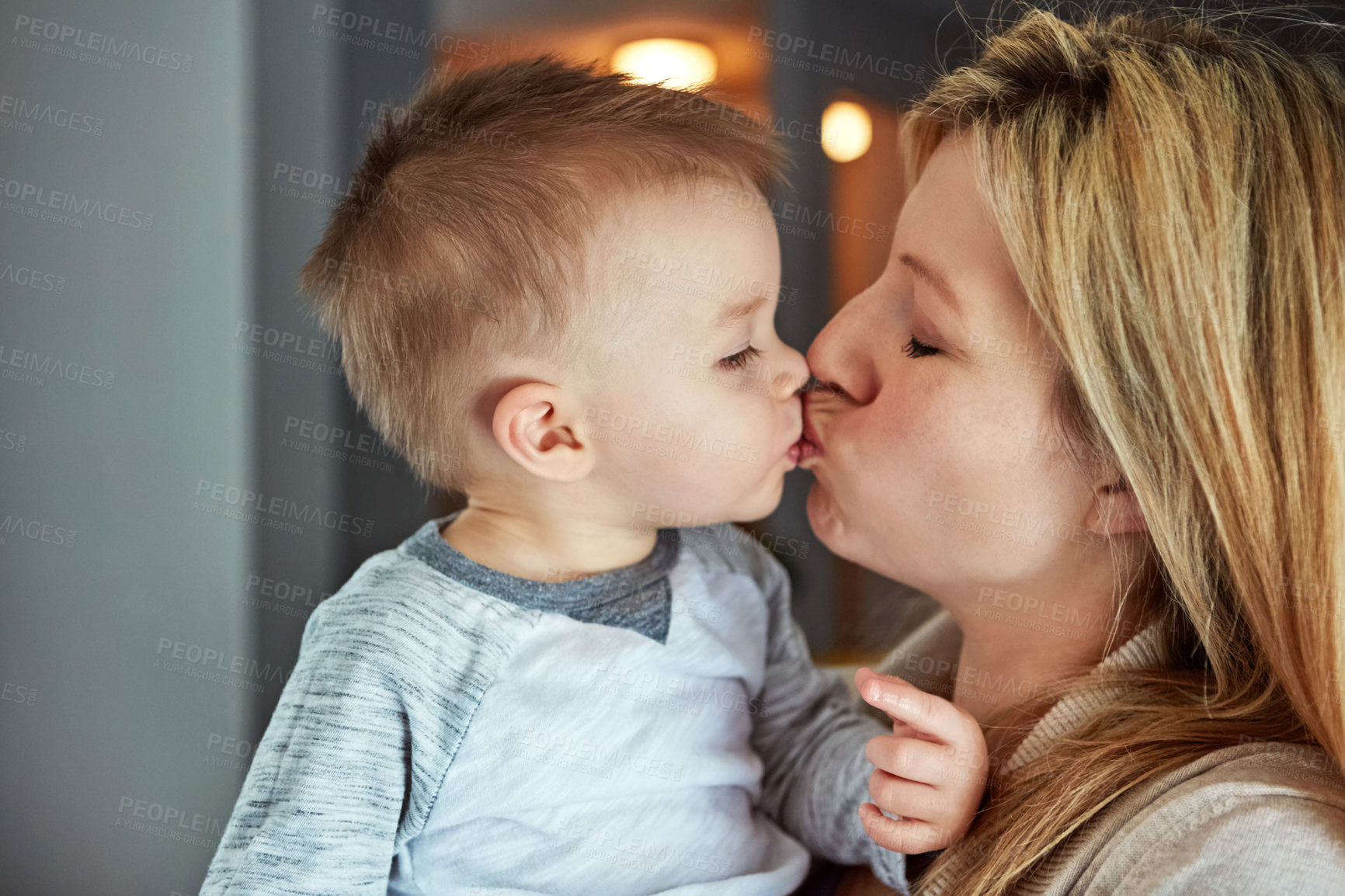 Buy stock photo Closeup shot of a young mother kissing her little boy