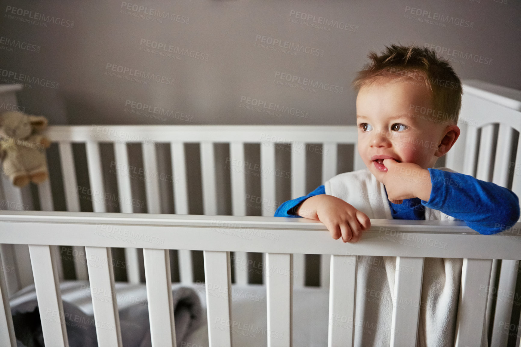 Buy stock photo Cute, happy and playful baby in nursery on a blanket for child development, fun and entertainment. Home, sweet and newborn for cheerful infant boy relaxing on a bed in his crib or bedroom cradle