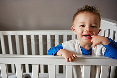 Buy stock photo Cute, portrait and playful baby in family home crib for child development, fun and childhood. Happy, sweet and wellness for cheerful small boy relaxing on a bed in his nursery or bedroom cradle