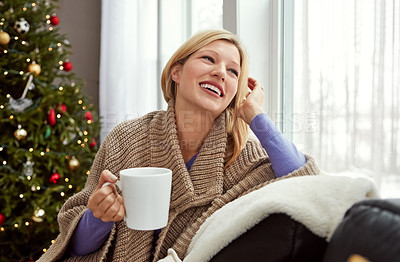 Buy stock photo Shot of a young woman relaxing at home with a cup of coffee