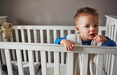 Buy stock photo Cute, playing and sweet baby in family home cradle for child development, fun and childhood. Health, wellness and happy for playful infant boy comfortable on a bed in his nursery or bedroom crib