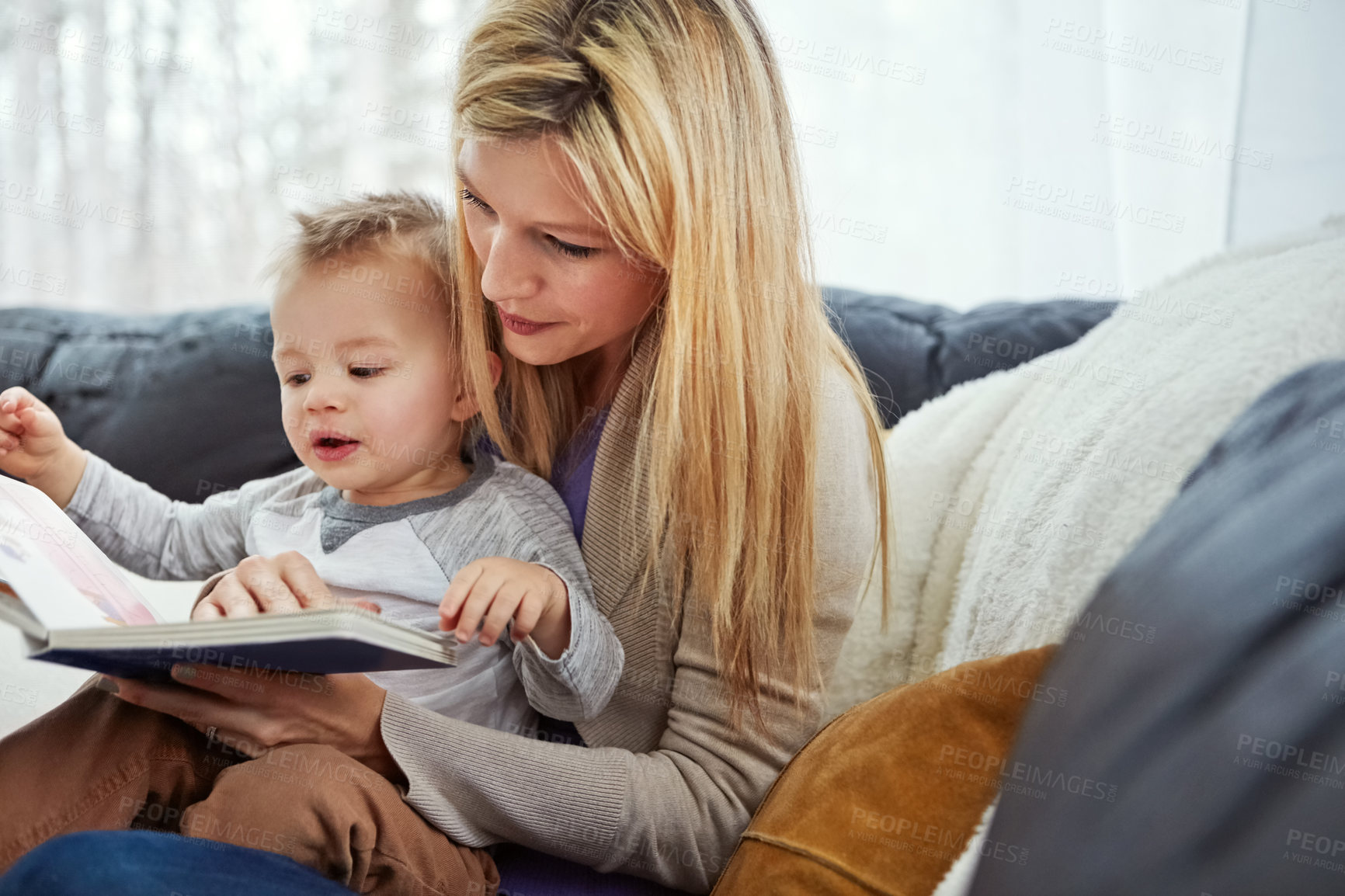 Buy stock photo Reading, mother and boy on sofa with book, teaching and learning in family home and education. Knowledge, fantasy and storytelling, mama and son relax in living room together with love, care and calm