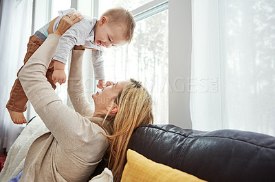 Buy stock photo Couch, playing and baby with mom, lounge and bonding with son, morning and love in apartment. Home, mother and toddler in living room, laughing and together on sofa, happiness and care for boy